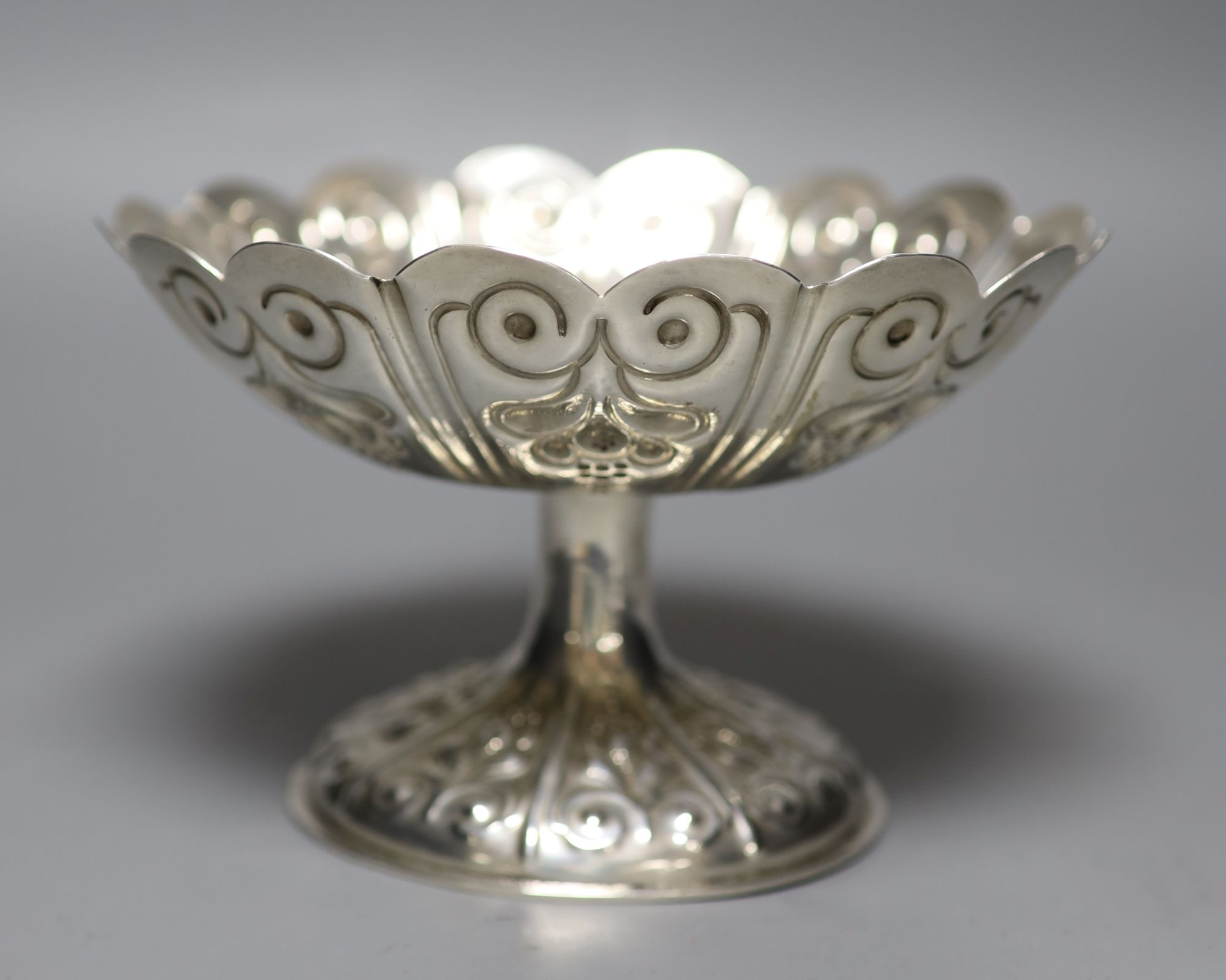 An Edwardian embossed silver circular pedestal dish of lobed form, George Nathan & Ridley Hayes, Chester 1906, 11.78oz.